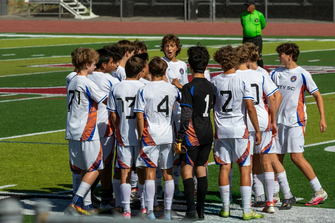 Equipo juvenil de fútbol reunido sobre el césped